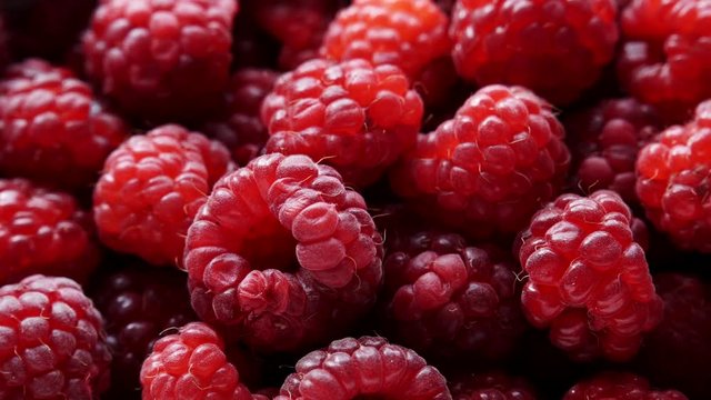 Fresh raspberry fruits as food background. Healthy food organic nutrition. View from above. Dolly slider shot 4K ProRes HQ codec