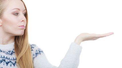 Teenage blonde woman pointing at copyspace