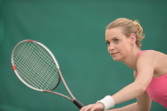 female tennis player preparing to hit