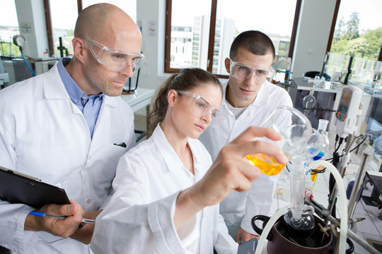 young scientists wearing protective glasses in clinical laboratory