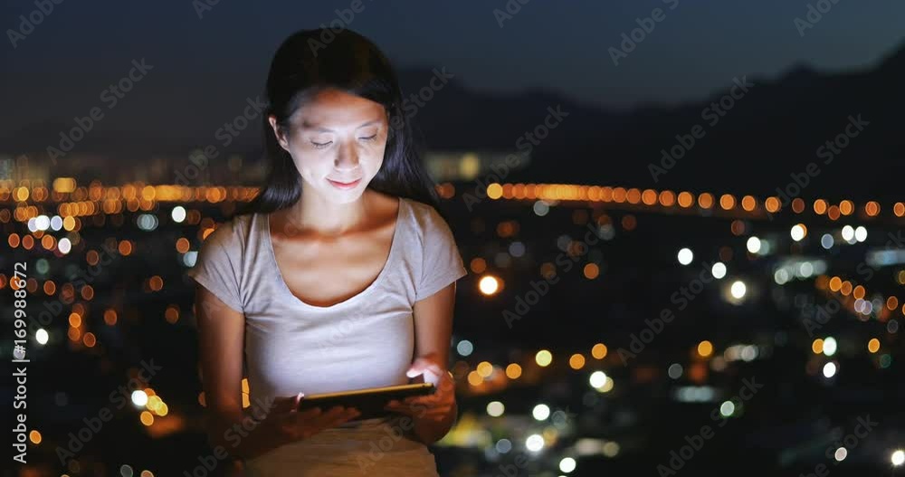 Canvas Prints Woman using tablet computer in the evening