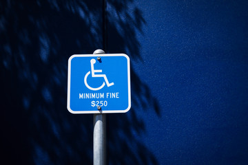 Handicapped parking sign and fine notice