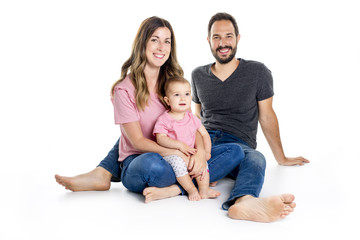 Photo of the happy young family with little child sitting on the floor