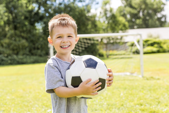 Portrait of young boy with soccer ball