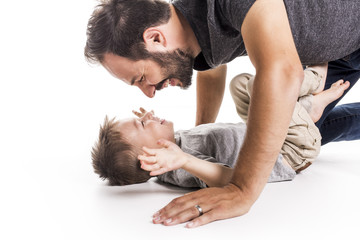 Father and son having fun over white background