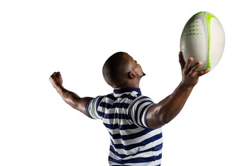 Sportsman with arms outstretched holding rugby ball