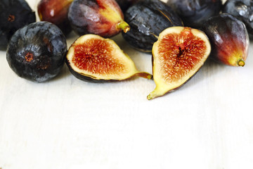 Whole figs and one fig sliced in half. Sekective focus