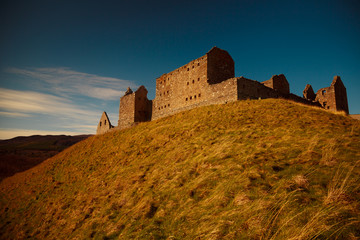 Scenic shot of an abandoned castle close to the Scottish Highlands, Scotland, UK during golden hour sunset
