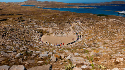 A wide angle shot featuring ancient amphitheater ruins in the Greek island of Delos