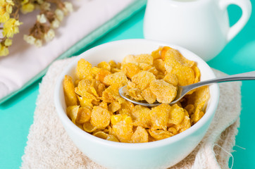 Corn flakes in a bowl with spoon for eating in the morning,breakfast or meal