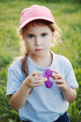 girl holding popular fidget spinner toy