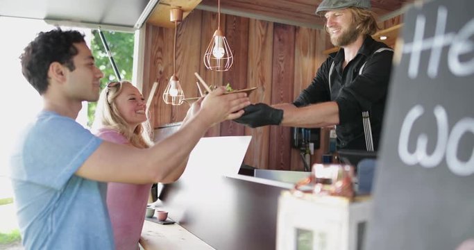 Food Truck owner serving customers healthy meal