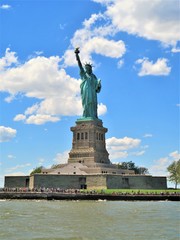 The Statue of Liberty in New York City with a blue sky background