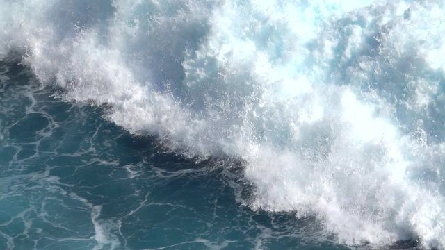 SLOW MOTION, CLOSE UP: Huge turbulent foamy ocean wave breaking. Perfect barrel wave rolling upon the shore and splashing. Big powerful swell wave crushing over the rocky reef spraying sea waterdrops