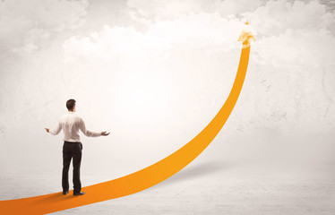 Business person standing on orange arrow