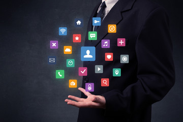 Businessman holding colorful applications