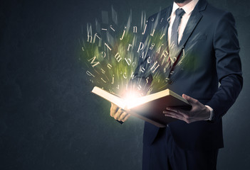 Businessman holding a book.