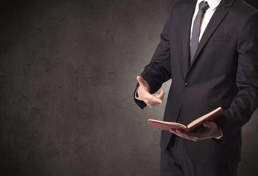 Businessman holding a book.