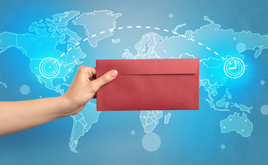 Hand holding envelope with global concept