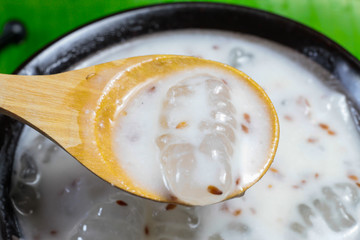 Caramelized crisps in coconut sauce. Thai dessert.