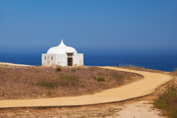 Fototapeta na wymiar Path near Ermida da Memoria or Memory Chapel of Nossa Senhora do Cabo Church near cape Espichel, Portugal