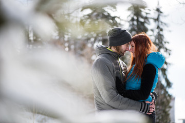 Winter couple touching foreheads. Love concept.