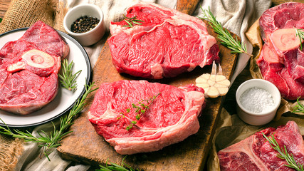 Raw beef meat on a dark wooden board.