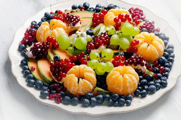 Various fresh fruits and berries on plate