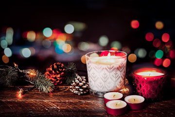 Christmas background - Christmas candle and rustic decoration on wood table with christmas lights background in night party. vintage color style.