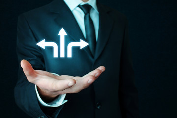 Businessman holding arrows. Decisions for the future.