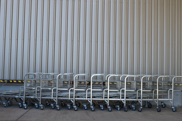 row of empty shopping carts in the big supermarket 