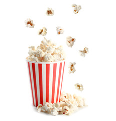 Cup and tasty popcorn on white background - obrazy, fototapety, plakaty