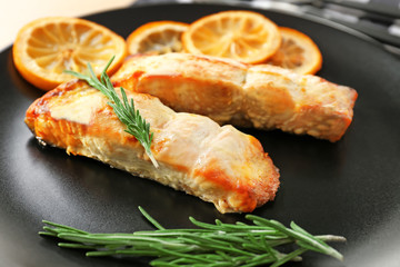 Plate with slices of lemon and salmon, closeup