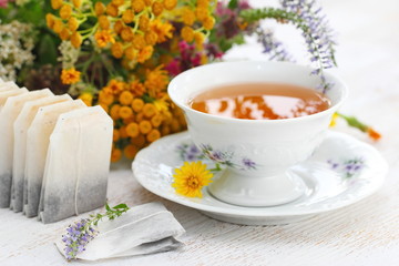 Cup of herbal tea and flowers