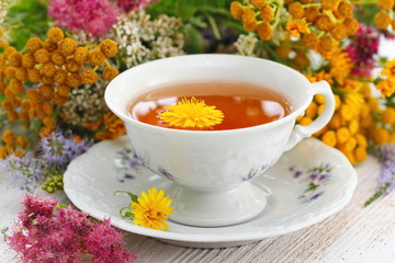 Cup of herbal tea and flowers