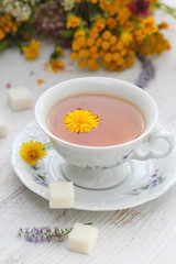 Cup of herbal tea and flowers