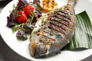 Plate with delicious fried fish, closeup