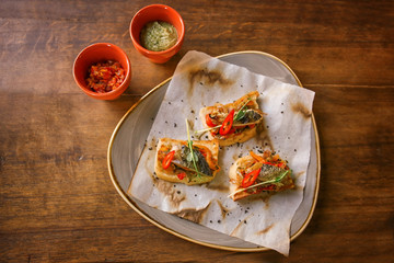 Delicious molletes with fillet of fish and vegetables on plate