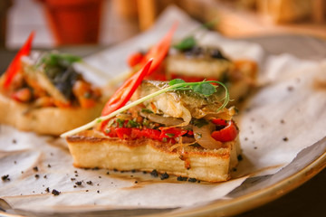 Delicious molletes with fillet of fish and vegetables on plate