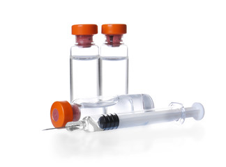 Ampules with vaccine and syringe on white background