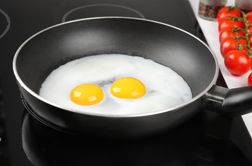 Cooking of delicious sunny side up eggs
