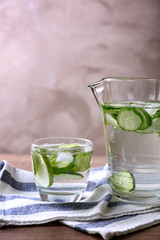 Composition of delicious refreshing water with mint and cucumber on table