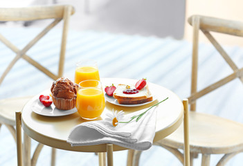 Table with delicious breakfast on the balcony