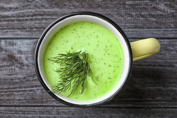 Delicious broccoli soup with fennel in mug on wooden background - obrazy, fototapety, plakaty