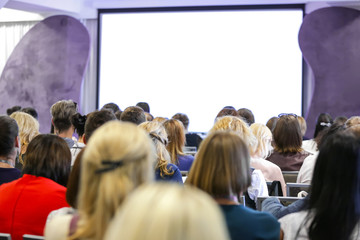 Many people during presentation in conference hall
