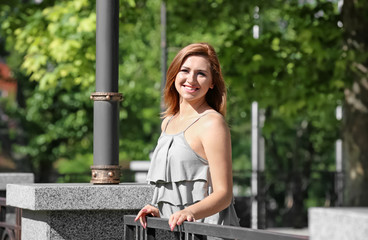 Beautiful young woman outdoors on sunny day