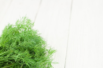 Heap of green fresh raw dill on old wooden white rustic planks