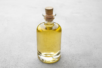 Obraz na płótnie Canvas Bottle of chamomile essential oil on table