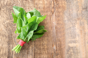 Fresh spinach bunch on wooden background