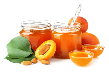 Apricot jam in jars and bowls, isolated on white